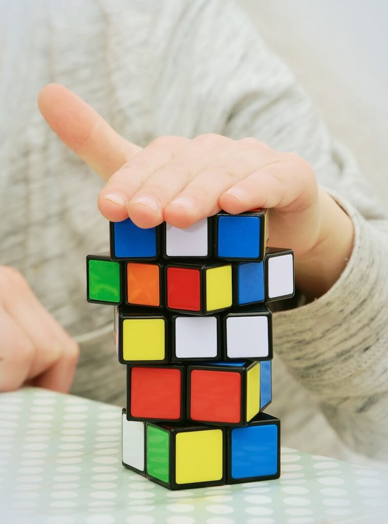 magic cube with someone's hand on top show their skills